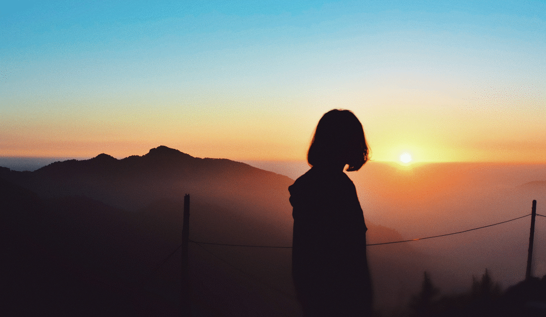 shadow of lady looking into the sunset